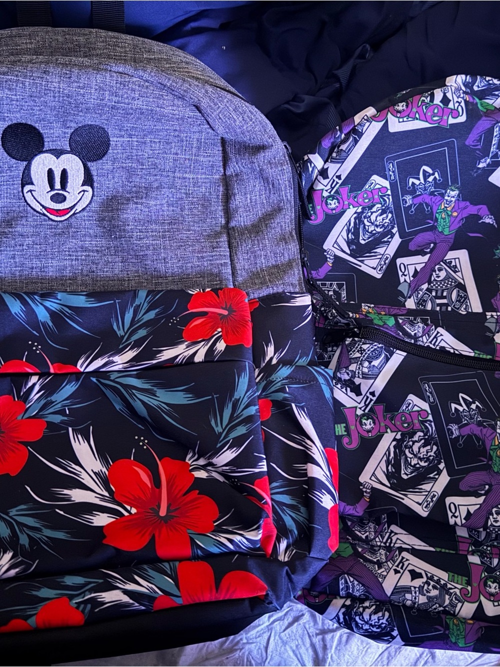 Two backpacks one joker and one micky mouse